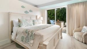 a white bedroom with a large bed and a window at 801 Mariners Club in Key Largo +37 photos