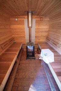 an inside of a wooden sauna with a stove at Wohlfühloase - Moderne Ferienwohnung mit großem eingezäuntem Garten in Alleinlage an Feld & Wald, Natur pur trifft auf Komfort, Wellness und gute Erholung in Alpen