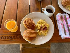 a table with a plate of breakfast foods and a cup of coffee at kontiki in Máncora