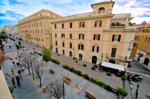 a large building with people walking in a street at Bed and Breakfast Port View in Civitavecchia