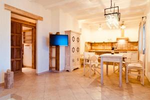 a dining room with a table and a tv at Isola Sarda Appart NICE in Murta Maria