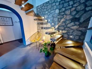 a set of stairs in a building with a yellow chair at Casa Flavia Apartment in Anacapri
