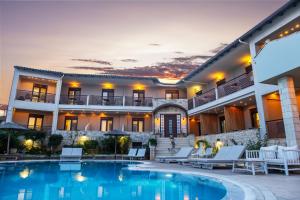 a villa with a swimming pool and a resort at Stamos Hotel in Afitos