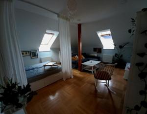 a room with a bed and a living room with windows at Apartment Dreamy Valley in Nenačovice