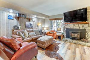 a living room with a couch and a fireplace at Walk to Shops & Eats: Mammoth Lakes Condo w/ Pool in Mammoth Lakes