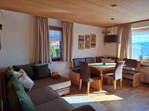 a living room with a couch and a table at Panorama in Sulzberg