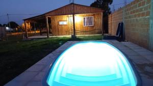 a light in front of a house at night at Dulce Morena in Concordia +2 photos
