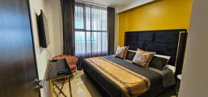 a bedroom with a bed and a television in it at Torre 5 Mazatlán Versace Style in Mazatlán