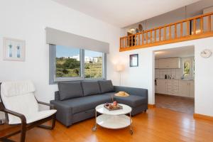 a living room with a couch and a table at Mavroudis House Sifnos in Sifnos