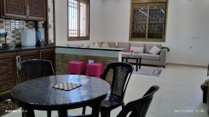 a kitchen with a table and chairs and a couch at Country House in Wadi Musa