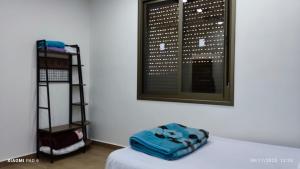a room with a bed and a window and a shelf at Country House in Wadi Musa
