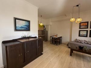 a living room with a couch and a table at Mariliana Apartments Just 15 Steps from the Libyan Sea in Myrtos