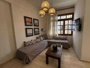 a living room with a couch and a table at Mariliana Apartments Just 15 Steps from the Libyan Sea in Myrtos +33 photos