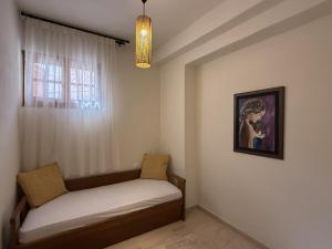 a small room with a bed and a window at Mariliana Apartments Just 15 Steps from the Libyan Sea in Myrtos