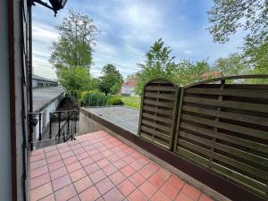 a wooden fence with a gate on a walkway at Entspannung pur! Privater Kinosaal & Whirlpool in Essen