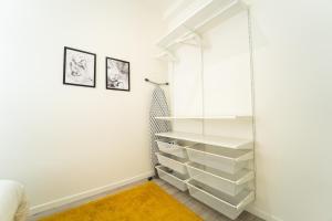 a walk in closet with white shelves at Yellow Two in Mons