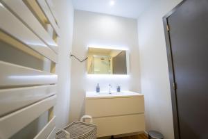 a bathroom with a sink and a mirror at Yellow Two in Mons