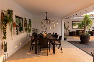 a dining room with a table and chairs at VILLA DA COSTA - SUNSET POOLHOUSE in Alvarães