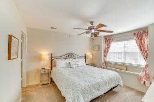 a bedroom with a bed and a ceiling fan at 3 Mi to Branson Landing Condo with Pool Access in Branson