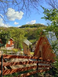 a wooden cabin with a fence in front of it at Kuca za odmor Lola in Ivanjica +43 photos