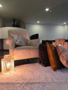 a living room with a couch and pillows at Casa do Engenho in Caldas de São Jorge