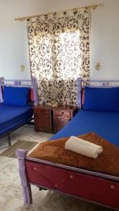 Un dormitorio con una cama azul con una toalla blanca. en Apartamento alquiler vacacional con vista a mar, en Agadir 24 fotos más