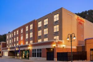 a large brick building on a street corner at Hampton Inn at Tin Lizzie Gaming Resort in Deadwood