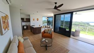 a living room with a couch and a ceiling fan at Casa Bonita at Hermosa Bay in Boca Chica