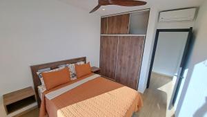 a bedroom with a bed and a ceiling fan at Casa Bonita at Hermosa Bay in Boca Chica +33 photos