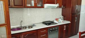 a small kitchen with a sink and a stove at Residencial Soares in Espargos
