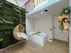 a bathroom with a swing and a glass tub at Loft avec Jaccuzi in Le Mans