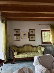a living room with a green couch on a wall at Villa in Valpolicella in San Pietro in Cariano +16 photos