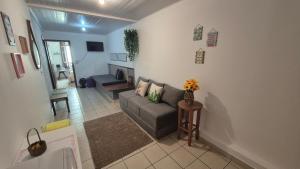 a living room with a couch and a table at Suite Flex ao lado da praca central in Domingos Martins