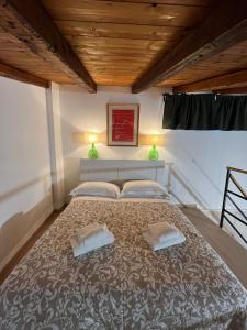 a bedroom with a large bed with two pillows at Donna Mariù in Catania