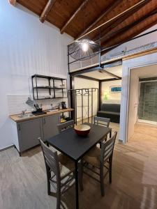 a kitchen and dining room with a table and chairs at Donna Mariù in Catania