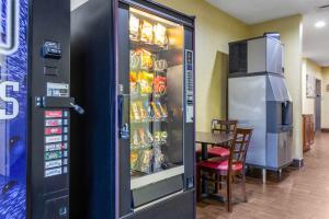 a soda vending machine in a restaurant with a table at Red Roof Inn Georgetown, IN - Louisville West in Georgetown