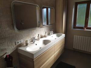 a bathroom with a white sink and a mirror at La maison des trois frontières in Wolschwiller +22 photos