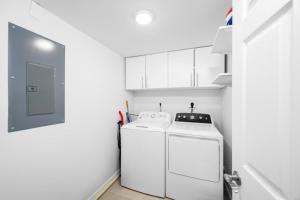 a white laundry room with a washer and dryer at Breakers West A3 condo in Sanibel