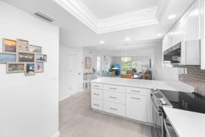 a kitchen with white cabinets and a white counter top at Breakers West A3 condo in Sanibel