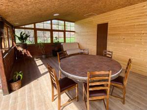a dining room with a table and chairs on a patio at Vikvid in Nišor