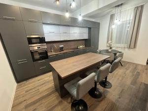 a kitchen with a wooden table and some chairs at Brothers House in Balatonszárszó