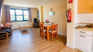 a kitchen and living room with a table and chairs at Duplex Colombres in Colombres +25 photos