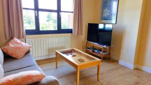 a living room with a couch and a coffee table at Duplex Colombres in Colombres