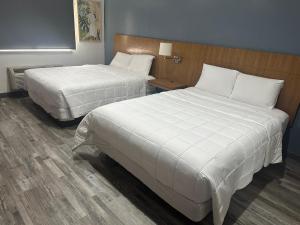 Postel nebo postele na pokoji v ubytování Extend a Suites
