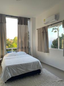 a bedroom with a bed and a large window at Luxury85 Blue in Bucaramanga