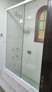 a glass shower in a bathroom with a window at Casa de Junqueira Mangaratiba in Mangaratiba +18 photos