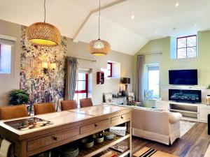 a living room with a large table and chairs at Summerhill Byre in Ballymena
