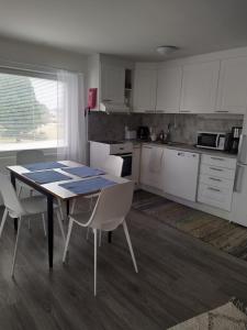 a kitchen with a table and chairs in a room at Lägenhet Lappfjärd in Lapväärtti