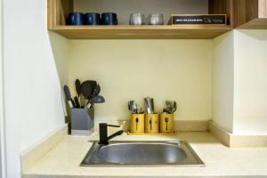 a kitchen counter with a sink and utensils at Apartment in Jounieh - J707 in Al Bāţiyah