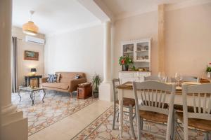 a living room with a table and a couch at Maltese Charm - Seaside Stay - Table Soccer in St. Julianʼs